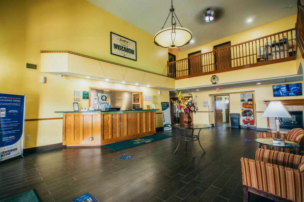 Photo of the lobby. The check in desk is along a yellow wall and seating areas are provided across from the desk