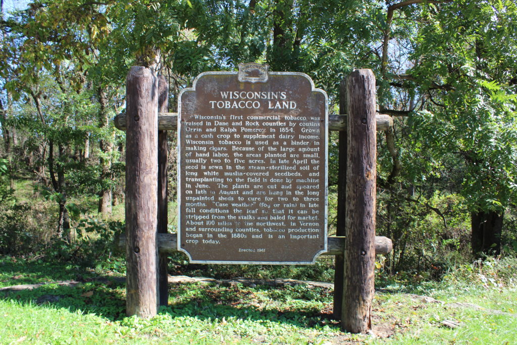 Wisconsin's Tobacco Land sign describing the history of tobacco in Edgerton. The sign sits in a grassy area outside