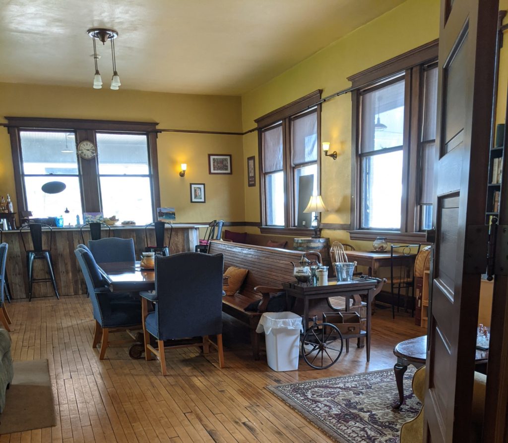 Interior of a coffee shop with cuches, tables, and chairs